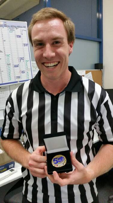 Basketball referee Matthew McLoughlin with his grand final medal.