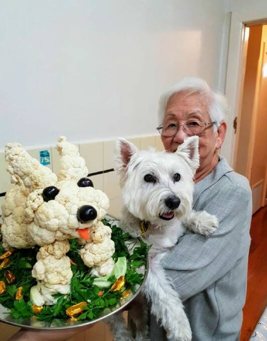 IDENTICAL: Lai Mun Chan with her adopted dog Annie and her rendition of Annie to celebrate the year of the dog for the Chinese New Year. Picture: CONTRIBUTED 