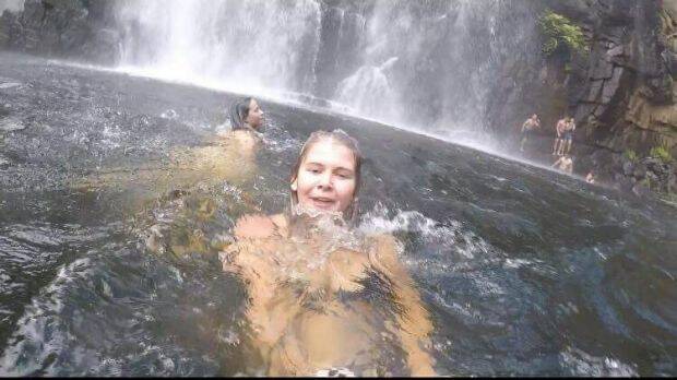 Anneka Bading films herself swimming near MacKenzie Falls, unaware a man has just slipped into the water. In the background his friends are frantically trying to rescue him. Photo: Anneka Bading