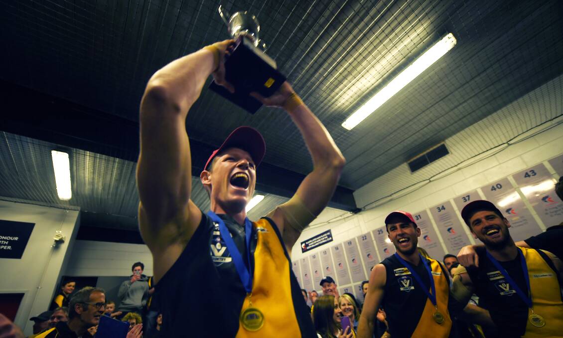SEE YOU LATER: Matt Tyler lifts the Central Highlands Football League premiership cup in 2015.