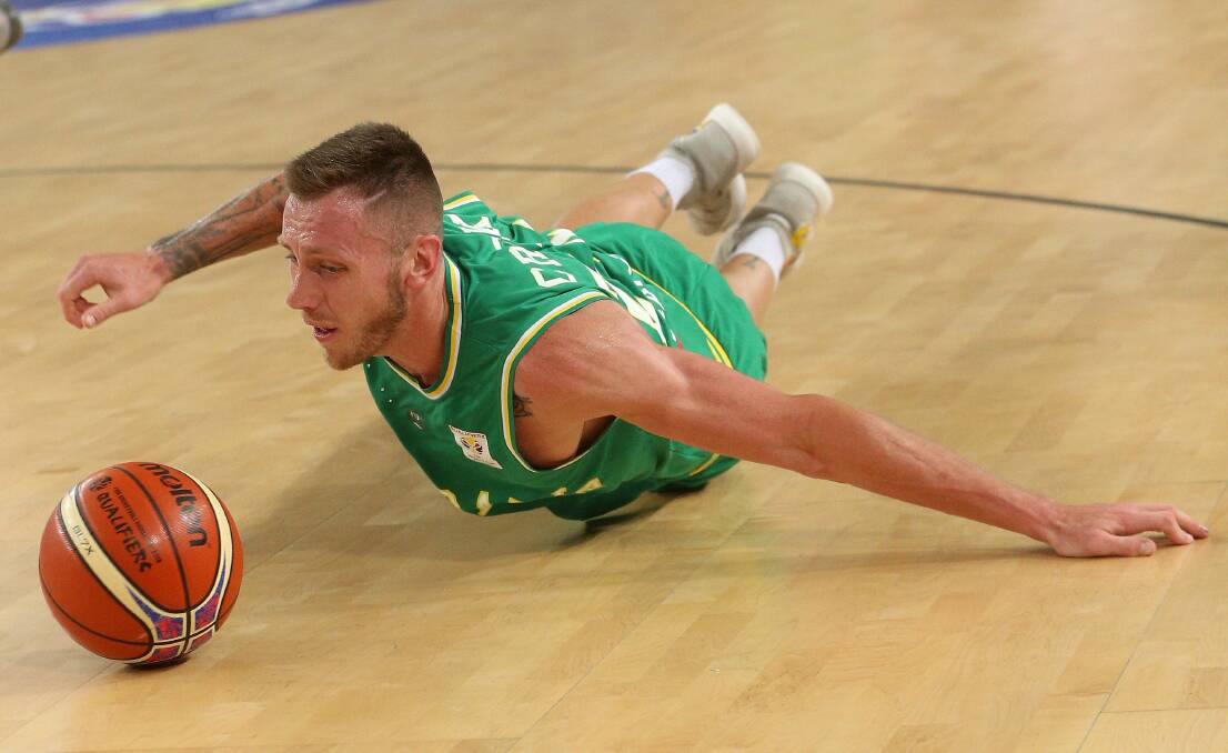 SLIDER: Mitch Creek shows his determination to get the ball while playing for the Boomers against the Philippines on Thursday night. Creek scored 12 points and grabbed 11 rebounds in the side's win. Picture: AAP IMAGES