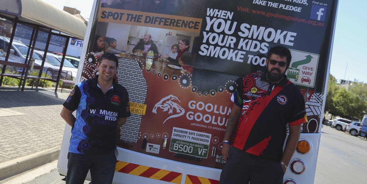 Goolum Goolum Aboriginal Co-operative's Dean O'Loughlin and Jarrod Newell with a bus highlighting the dangers of passive smoking. Picture: CONTRIBUTED