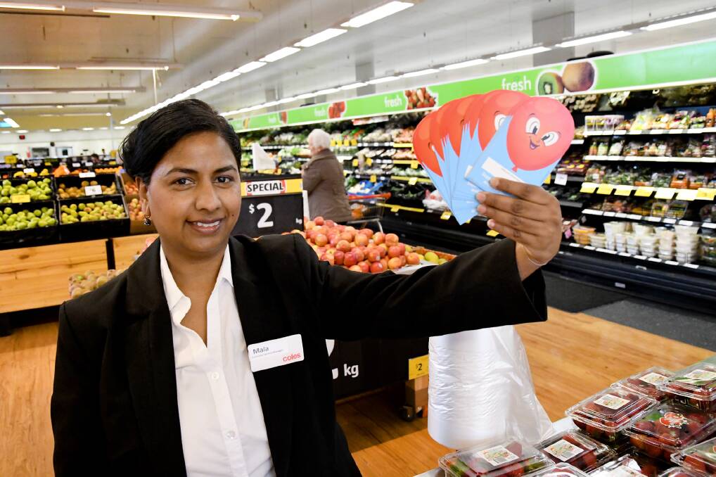HELPING HAND: Coles Horsham customer service manager Mala Govender with Very Special Kids donation cards. Picture: SAMANTHA CAMARRI