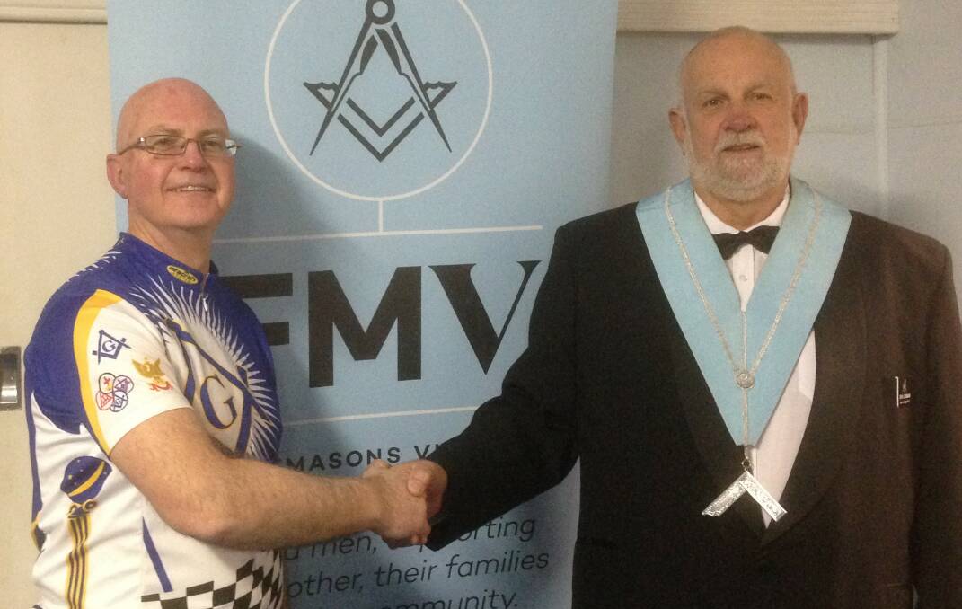 Ride for headspace 2018 organiser Worshipful Brother Malcolm Mann and Lowan Lodge Worshipful Master John Dunbar shake hands after a presentation about the ride at the lodge in Nhill earlier this year. Picture: CONTRIBUTED