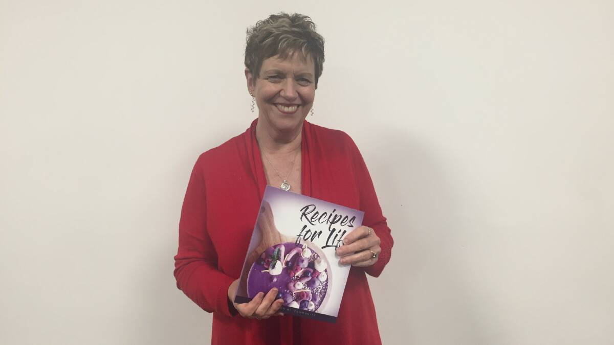 POIGNANT: Horsham and District Relay For Life committee fightback co-ordinator Lorinda Buckman with the group's cookbook, Recipes for Life. Picture: CONTRIBUTED