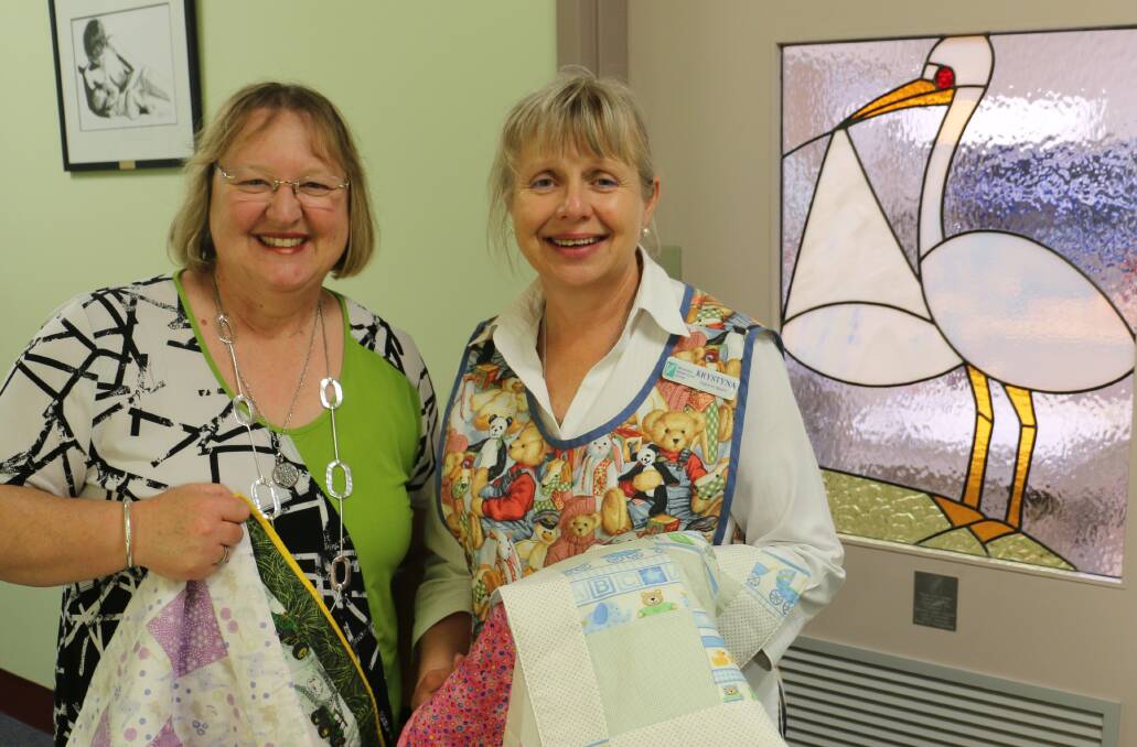 Kaniva Windmill Stitchers member Jenny Wallis presents Yandilla midwife Krystyna Wesolek with quilts the group made for Wimmera families with stillborn babies. Picture: CONTRIBUTED