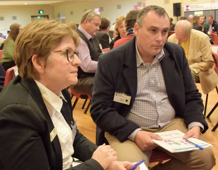 Kaye Borgelt and Shane Roberts, working as part of the health discussion group, work through their ideas at the Wimmera Southern Mallee Regional Assembly on Wednesday night. Picture: CARLY WERNER