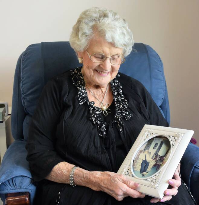 Lorna Uebergang looks at a photo of her late husband Alan.