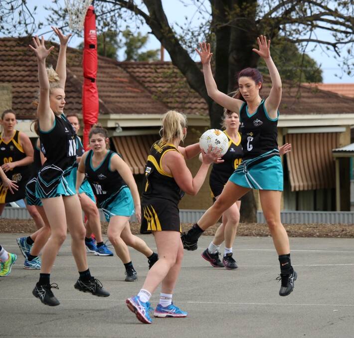 SIMON SAYS JUMP: Swifts' Jorja Folkes and Courtney Morrow apply pressure on their Pimpinio opponent. Picture: Trish Ralph. 