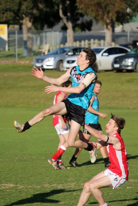 IN FRONT: Andrew Cameron leaps for the ball. Cameron finished with eight goals in the thrashing of Taylors Lake. Picture: Trish Ralph.