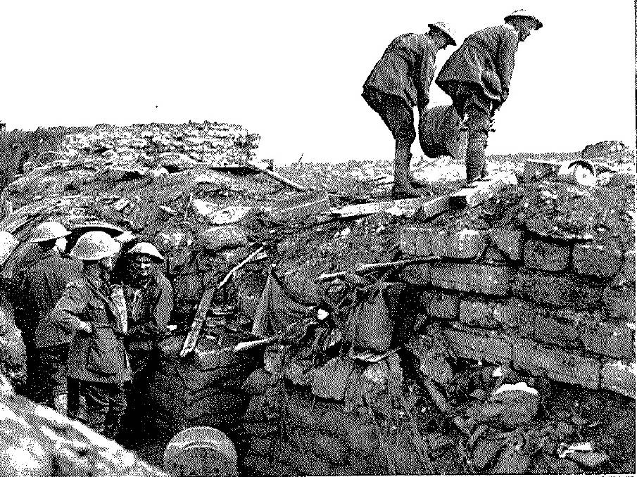 CONNECTION: Two signallers work to lay a reel of cable to a forward post. Surface lines were used in places where buried cables had been cut. 