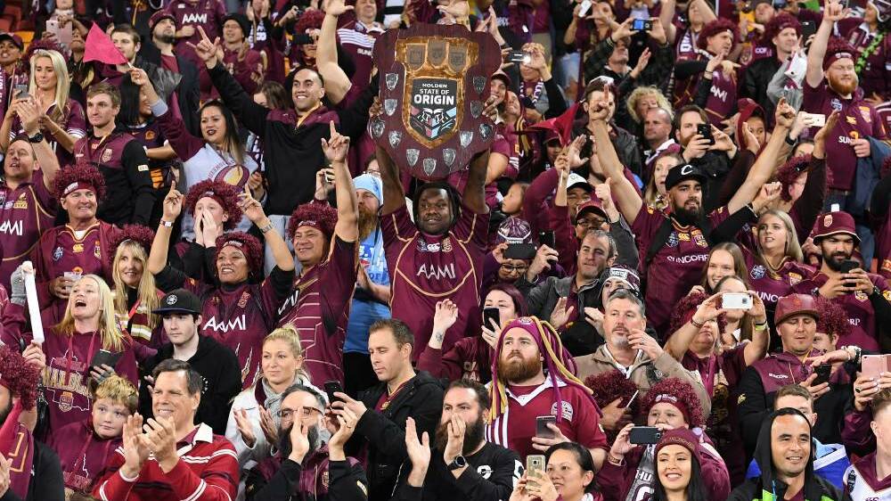 Spectators celebrate following the State of Origin Game 3 between the Queensland Maroons and NSW Blues, at Suncorp Stadium in Brisbane, on Wednesday, July 12, 2017. (AAP Image/Dave Hunt)