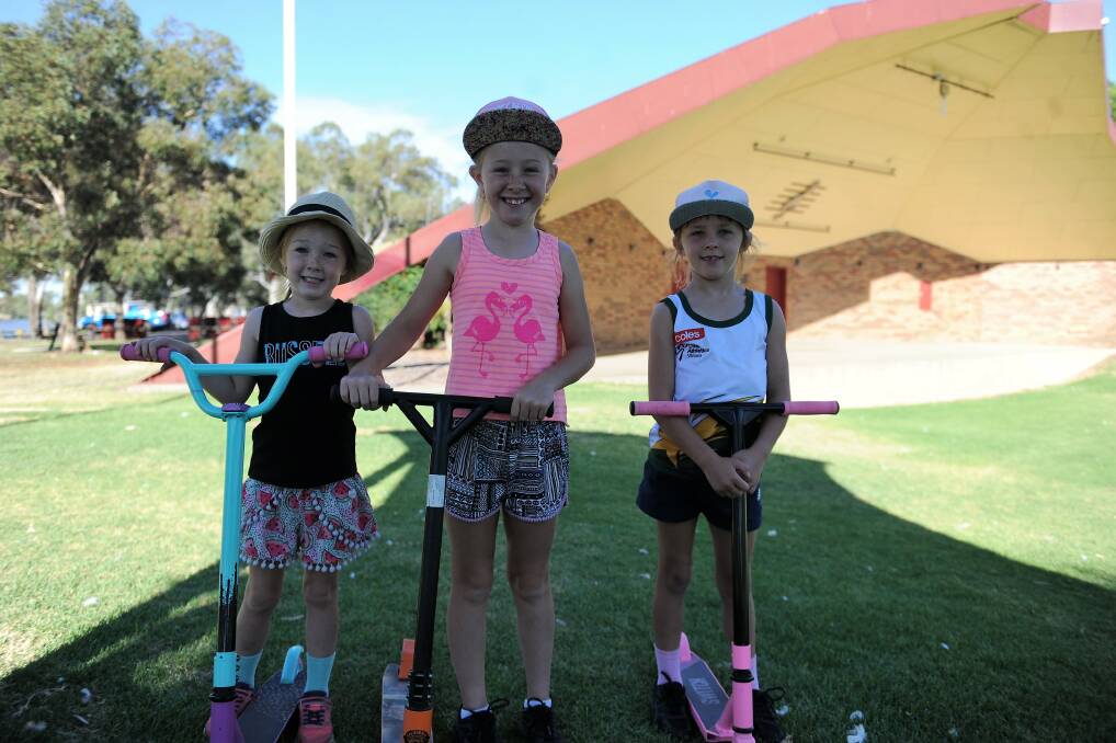 SCOOTING AROUND: Horsham's Hallam sisters Jayda, 5, Ella, 9, and Karla, 7 get ready to scoot around Sawyer Park in Horsham at the weekend. They were out with their dad Garry before it got too hot.