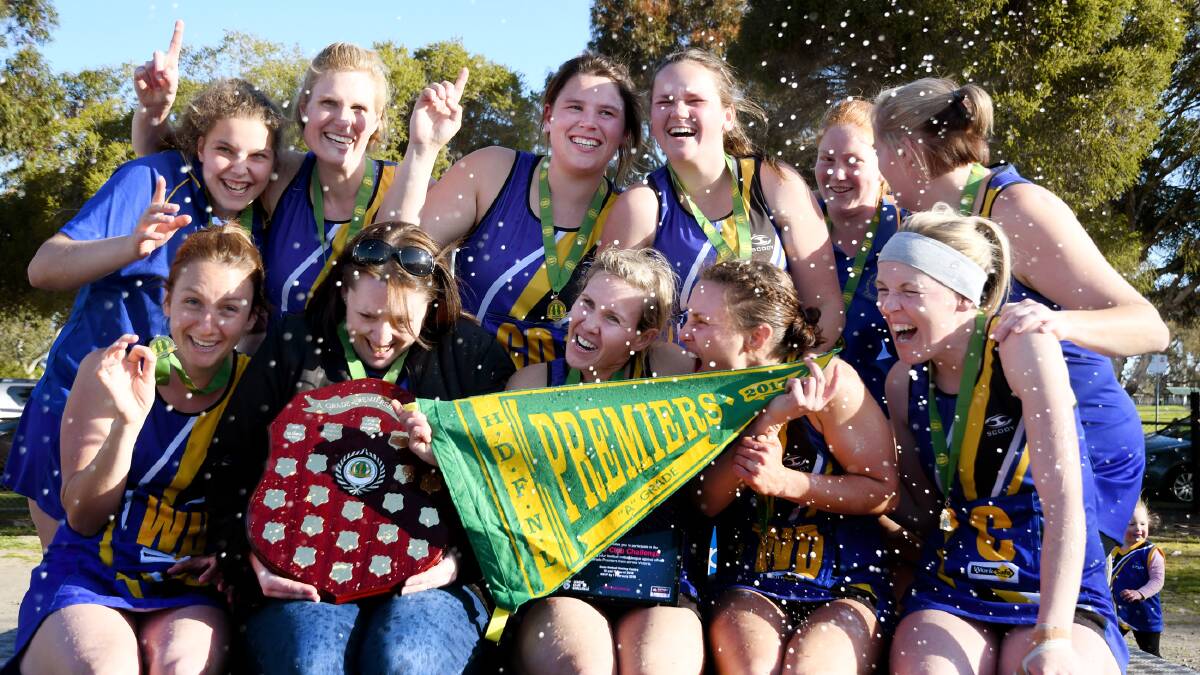 Natimuk United A Grade netballers are sprayed with champagne after their three-goal win against Harrow-Balmoral. Picture: SAMANTHA CAMARRI