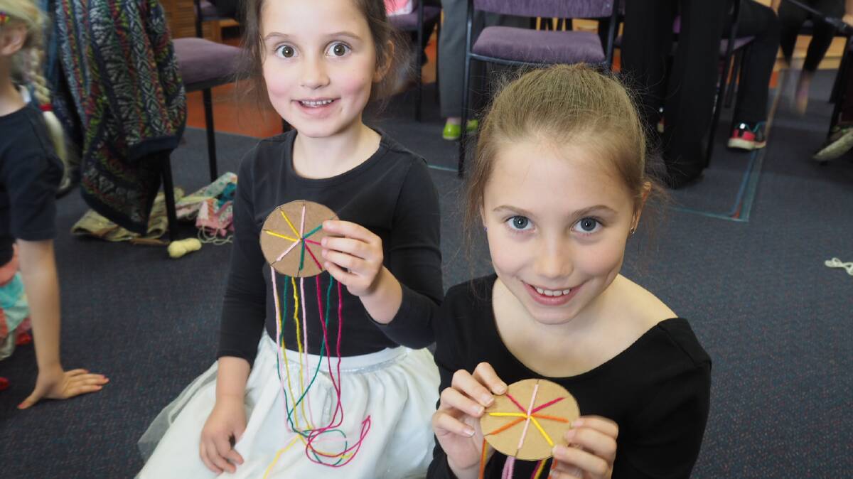 CREATIVE: Lara, 5, and Imogen Jaensch, 8, making friendship bracelets at school holiday programs in Horsham this week. Picture: DAINA OLIVER