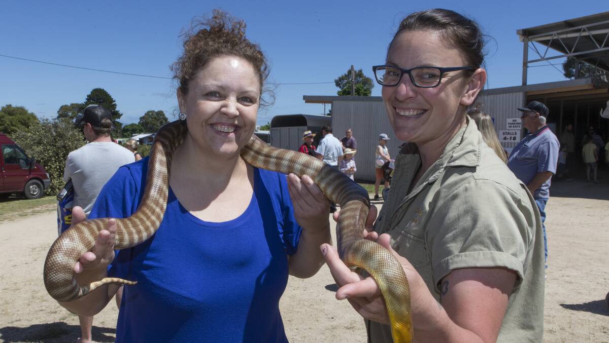 Sharlene Amasiah overcame her fear of snakes with the help of Alesha Bunting at the Stawell Show on Saturday. Picture: PETER PICKERING
