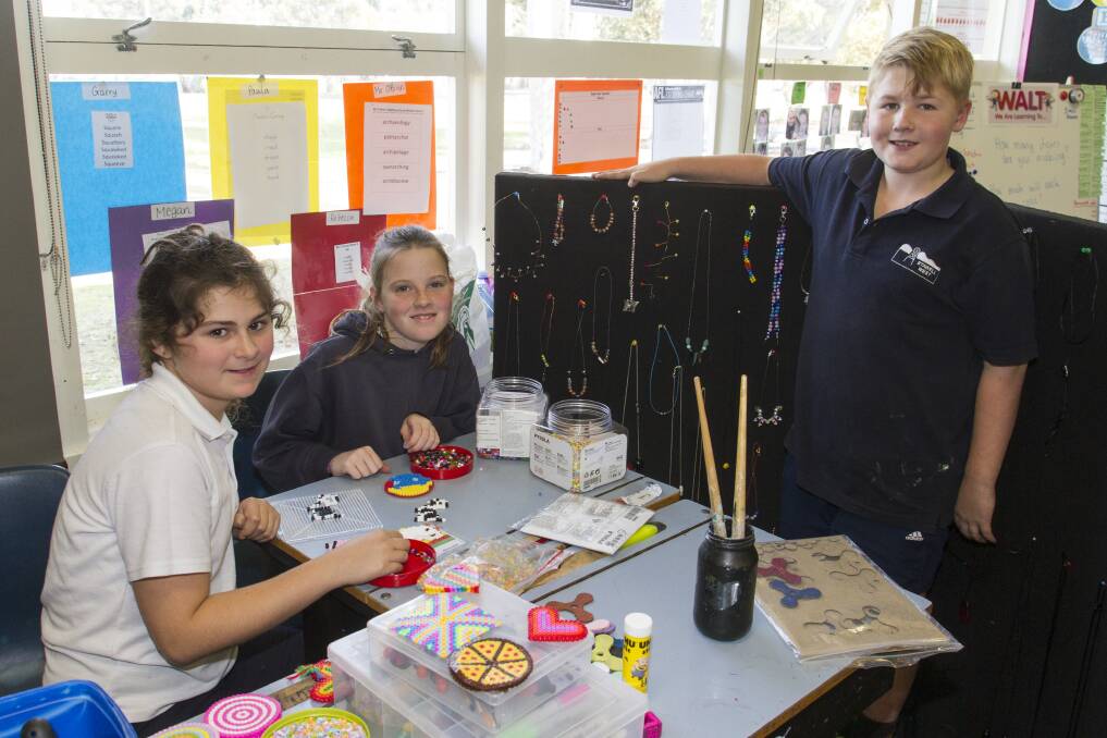 CREATIVE: Stawell West Primary students Annie, Jacinta and Oliver busy preparing for their school's mini market on Wednesday, June 28. Picture: Peter Pickering