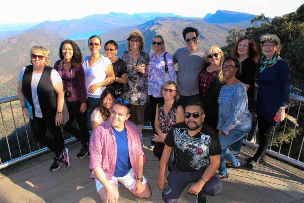 The international travel agents pose for photos at the Grampians' Boroka Lookout
