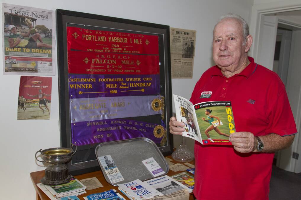 MILESTONE: Bob Cashin is full of stories and memorabilia as he looks at a record from a past Stawell Gift. Picture: Peter Pickering