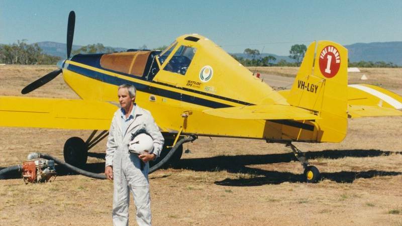 REMARKABLE CAREER: Keith Davidson pictured alongside an old fire bomber at the Stawell airport. Picture: CONTRIBUTED