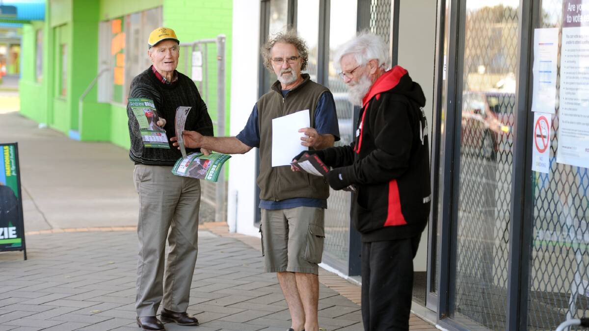 Political party volunteers hand out how-to-vote cards at the Horsham early voting centre. Picture: PAUL CARRACHER