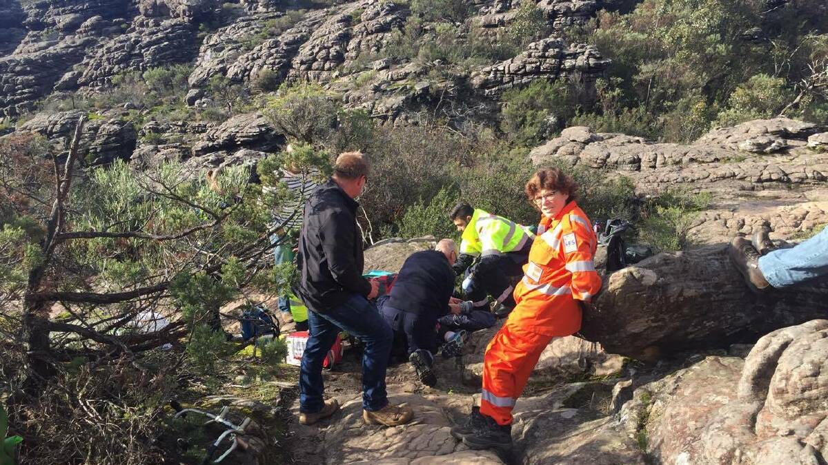 SES and paramedics treat a 42-year-old Ballarat woman who suffered a suspected broken ankle in the Grampians on Saturday. Picture: CONTRIBUTED.