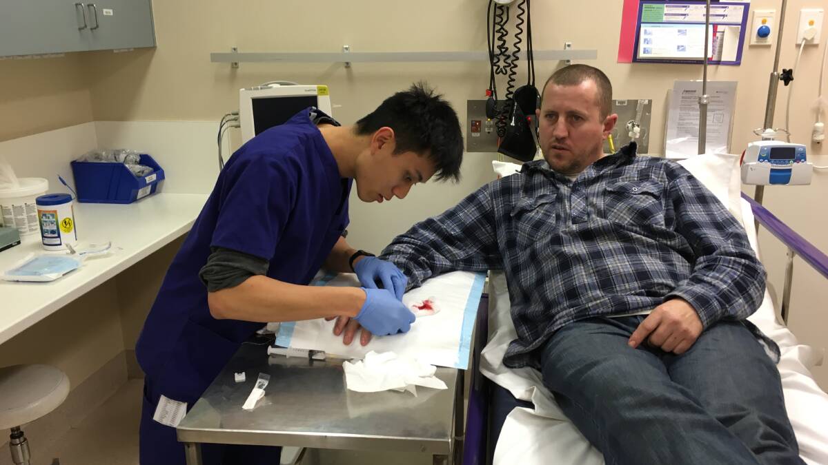 Dr Jordan Lee treats Matt Heard, from Horsham, for a cut thumb in the Wimmera Base Hospital Emergency Department. Picture: REX MARTINICH