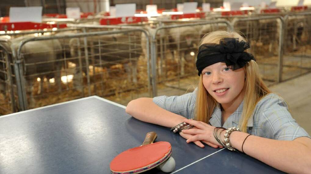 Elly Blakeley plays table tennis at Maydale Pavilion with sheep in the background in 2013. Picture: PAUL CARRACHER