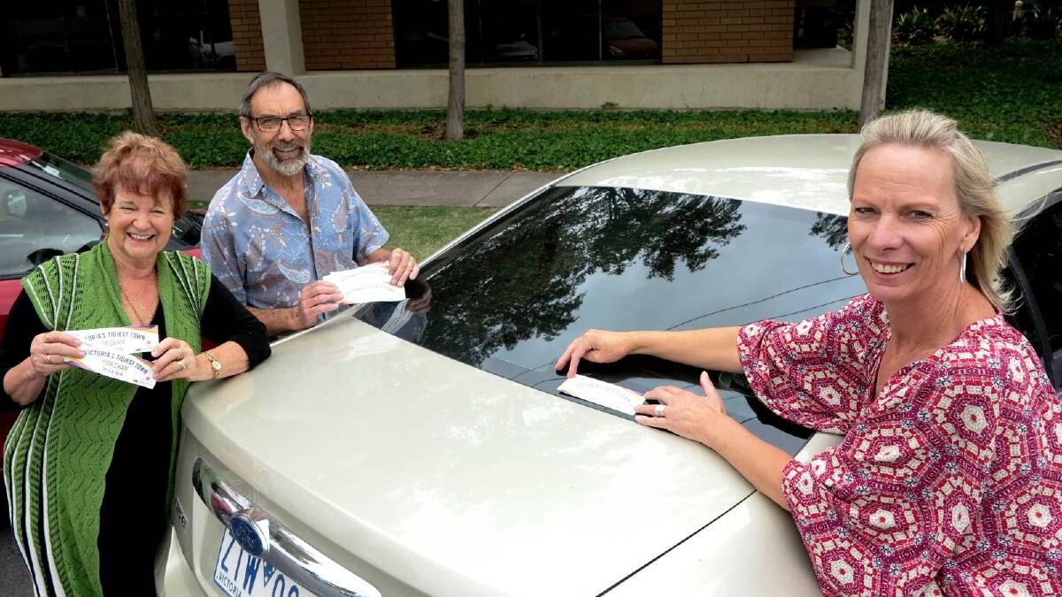 Jan Morris OAM, Rotary Club of Horsham East member Don Mitchell, and Business Horsham's Wendy Mitchell with the free parking bumper stickers now available for next Friday’s free parking day. Picture: CONTRIBUTED