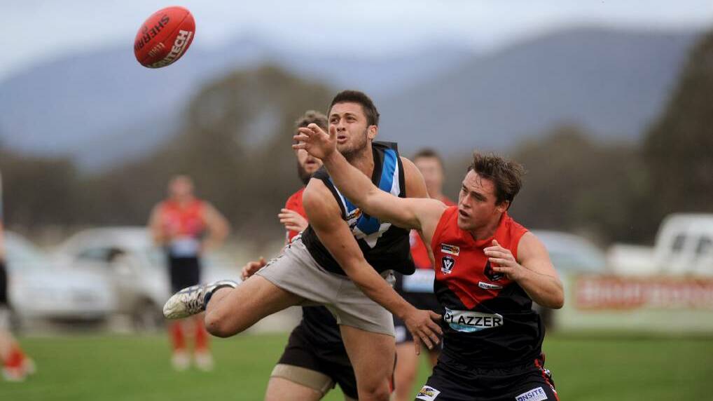 Swifts' Ricky Whitehead and Laharum's Zack Price at Cameron Oval in 2014. Picture: SAMANTHA CAMARRI