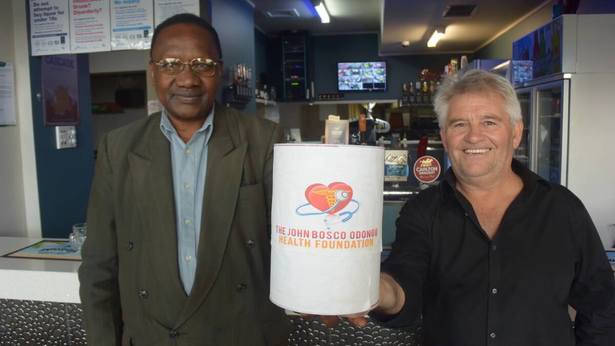 GIVE: JBO Health Foundation executive director John Bosco Odongo and Horsham Commercial Hotel part owner Gary Jellyraise funds for a new hospital in Uganda. Picture: REX MARTINICH