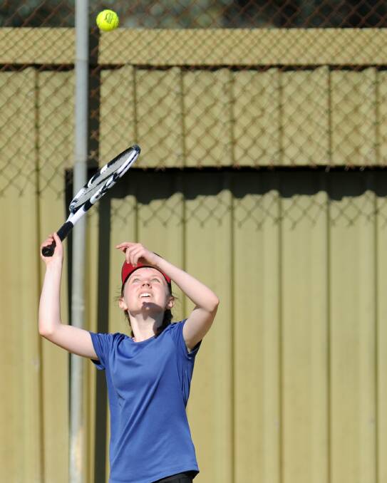 Grace Crawley serving in last season's junior tennis grand final. 