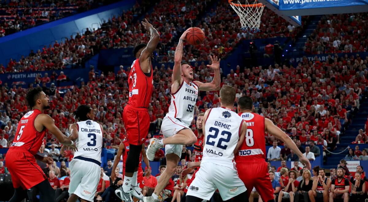 LEAP: Mitch Creek reaches for a dunk against the Perth Wildcats on Friday night during the Adelaide 36ers semi-final win. Picture: AAP