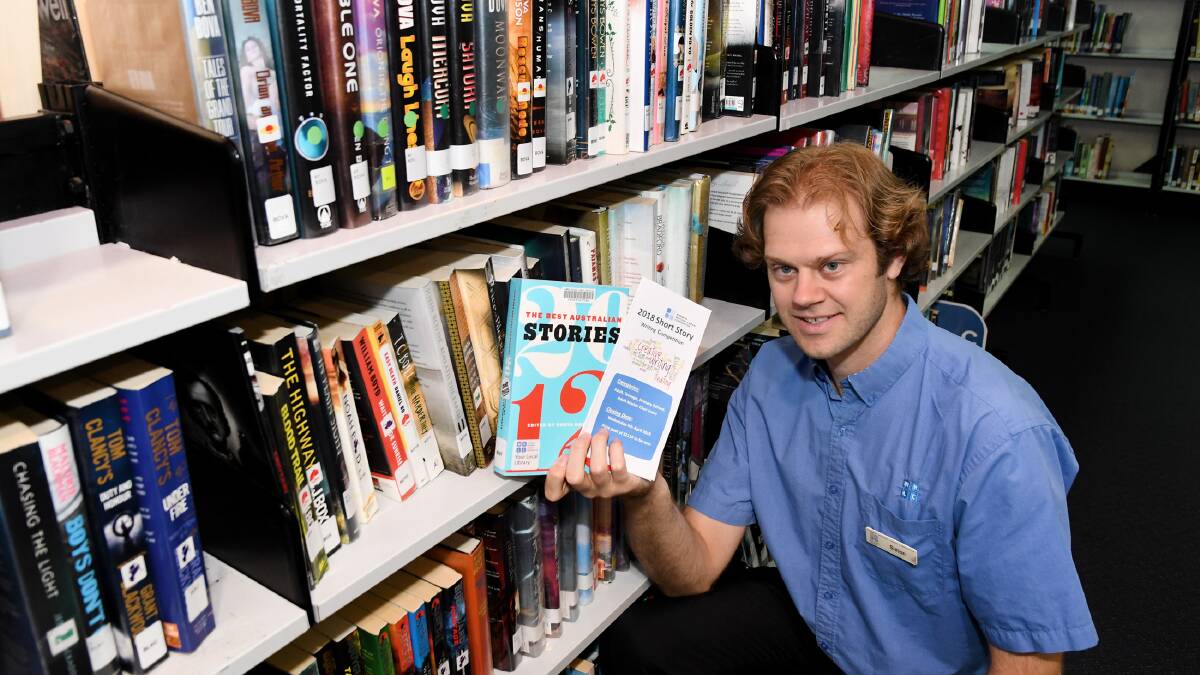 START WRITING: Simon Grosser of the Wimmera Regional Library in Horsham with a collection of short stories. Picture: SAMANTHA CAMARRI