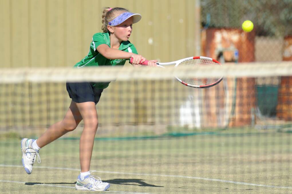COACHING BOOST: Ella Thompson plays a shot for Haven in a junior tennis grand final last season. 