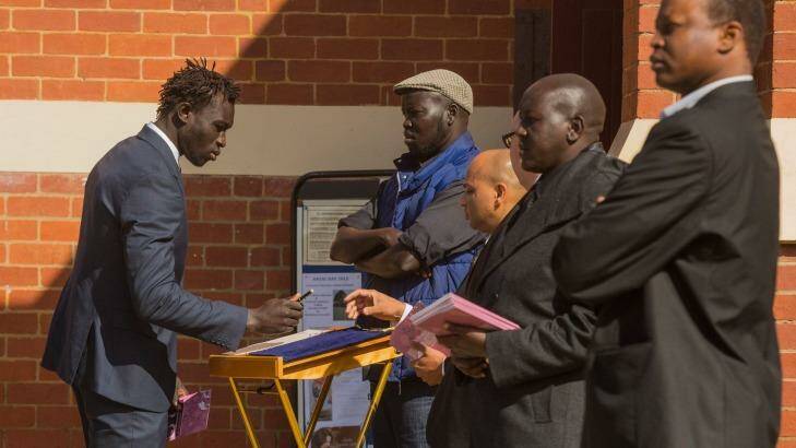 AFL footballer Majak Daw attends the funeral for for Bol, Anger and Madit. Photo: Chris Hopkins