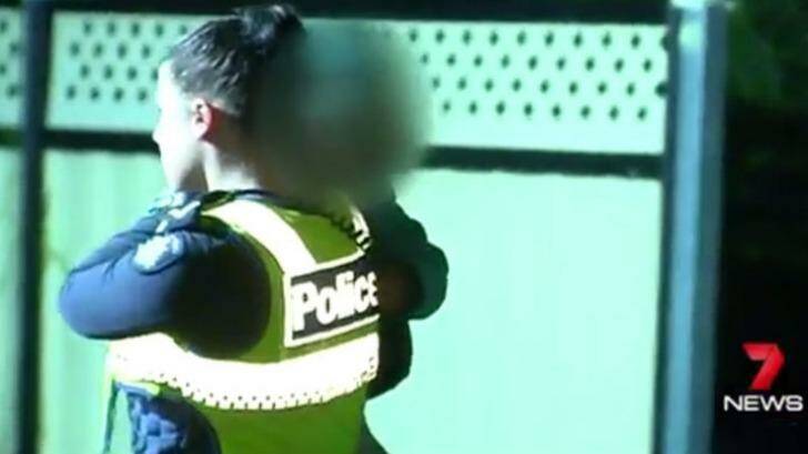 A toddler is carried from the Broadmeadows house on Monday night.   Photo: Courtesy of Seven News