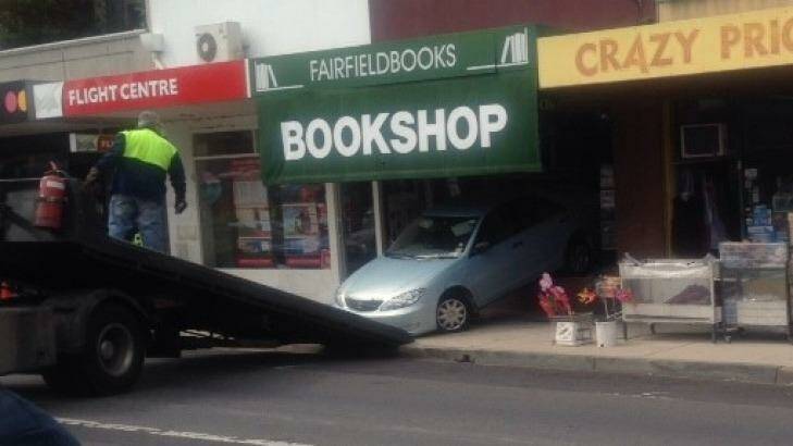 The car is removed from the bookshop in Northcote. Photo: Tanya Adams