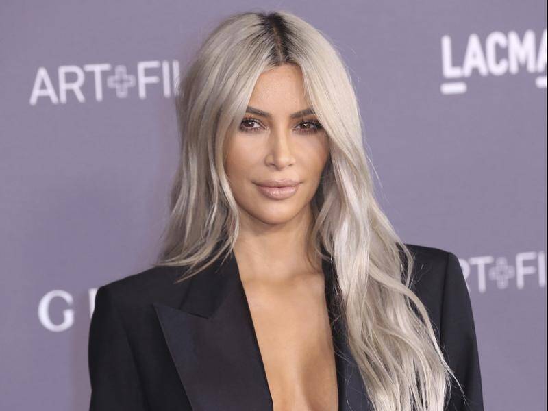 Kim Kardashian West has ditched her blonde hair to return to her natural brown, saying "I'm back!"