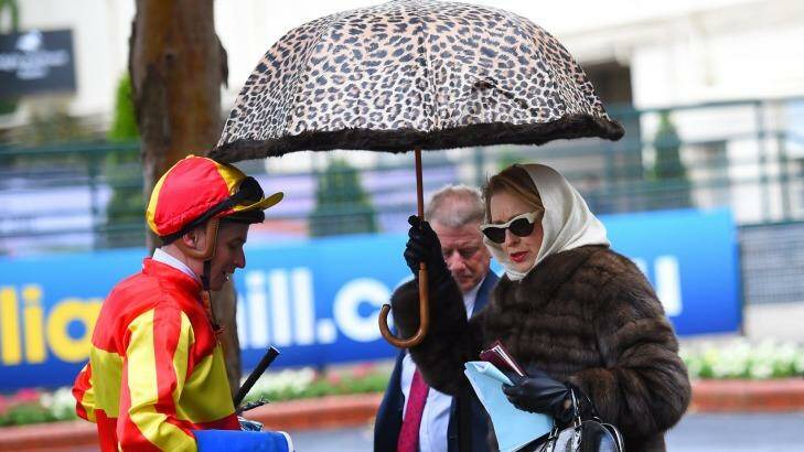 Trainer Gai Waterhouse keeping dry after Race 1 during Cox Plate day at Moonee Valley Racecourse on Saturday. Photo: Vince Caligiuri