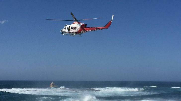 The HEMS4 rescue helicopter searches the Warrnambool breakwater. Photo: Jarrod Woolley, The Standard