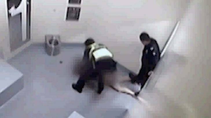 Video still shows a police officer standing on a woman's legs while she is in custody in Ballarat.