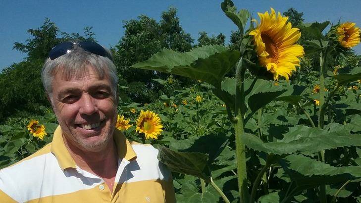 Ballarat man Lawrence Richmond in a sunflower crop growing on a farm in Ukraine. Photo: Supplied