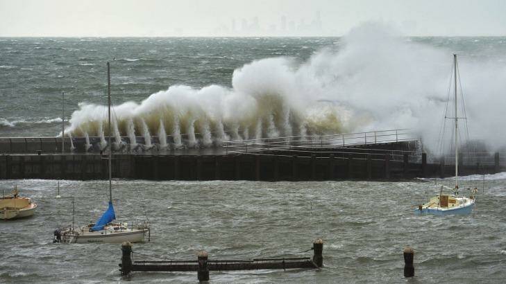 A large wave crashes against the Mornington Pier during Tuesday's storm. Photo: Joe Armao