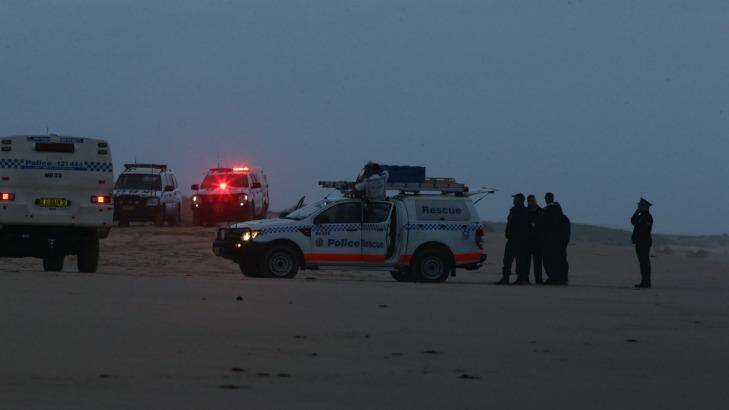 Police at the scene where two bodies washed up on Stockton Bight. Photo: Peter Stoop