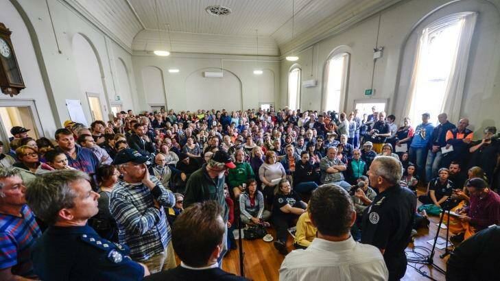 Officials front angry locals at a community meeting in Lancefield. Photo: Justin McManus
