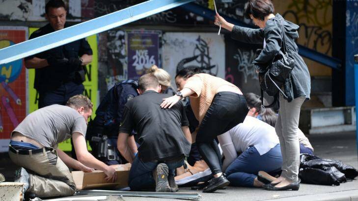 Bystanders rushed to help the injured. Photo: Justin McManus