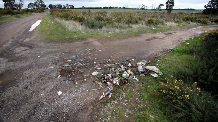 Scattered rubbish at the site where a couple and their dog were found dead in their car on this corner on the outskirts of Ballarat. Photo: Angela Wylie