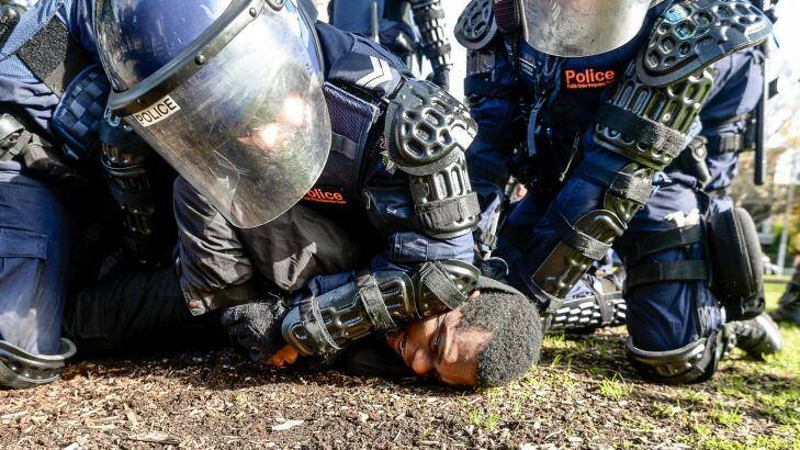A protester was arrested by riot police after damaging an Age photographer's camera. Photo: Justin McManus