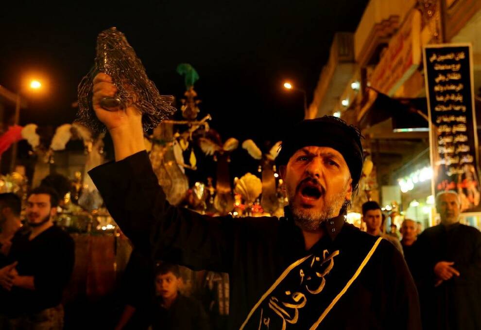 Centuries-old ritual: A Shiite Muslim man flagellates himself during an Ashura procession to the Shrine of Imam Musa al-Kadhim in Baghdad's northern suburb of Kadhimiya on Thursday. Photo: Kate Geraghty